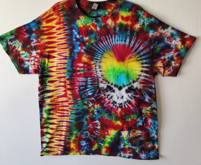 Tie-dye shirt with skull and rainbow design.