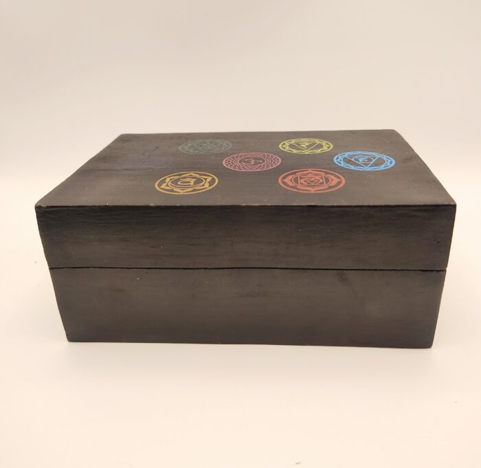 Black wooden box with chakra symbols.