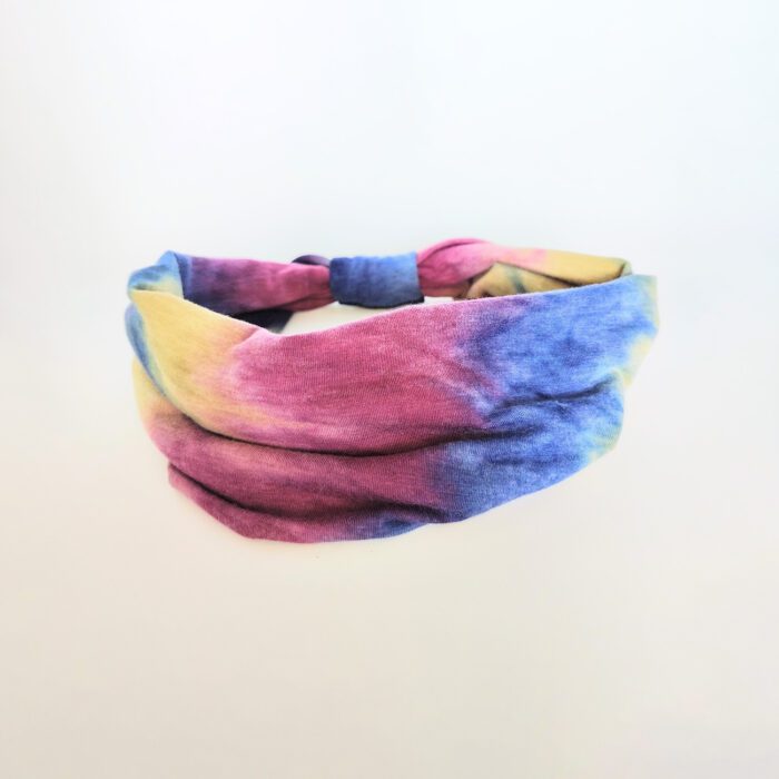 Tie-dye headband with yellow, blue, and pink.