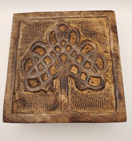 Wooden box with carved tree design.