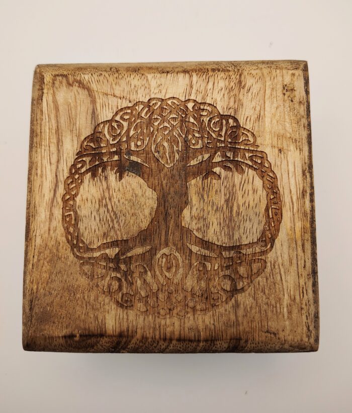 Wooden square with tree of life carving.