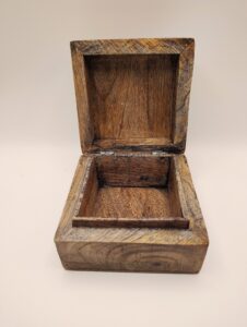 Open wooden box with lid up.