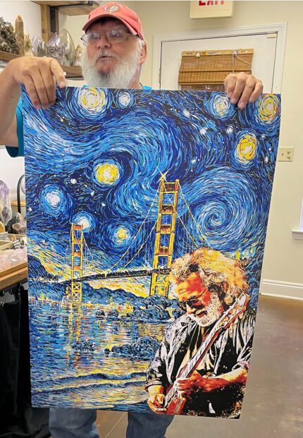 Man holding a Golden Gate Bridge painting.